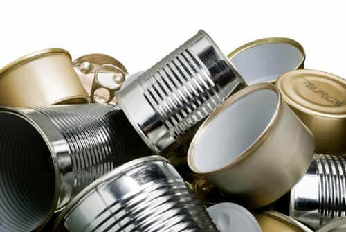 Operatives loading a skip wearing high-visibility PPE